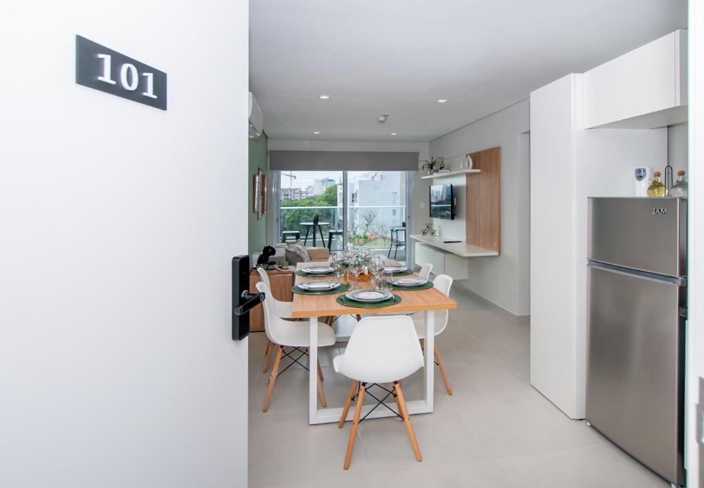 a kitchen and dining room with a table and refrigerator at Stylish 2BR Apt in Top Location in Asunción
