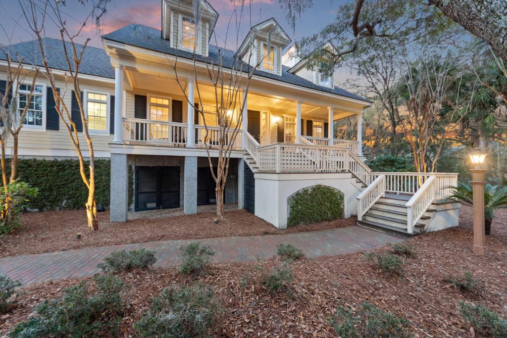 a large white house with a porch and stairs at MH3012: 3012 Marsh Haven in Seabrook Island