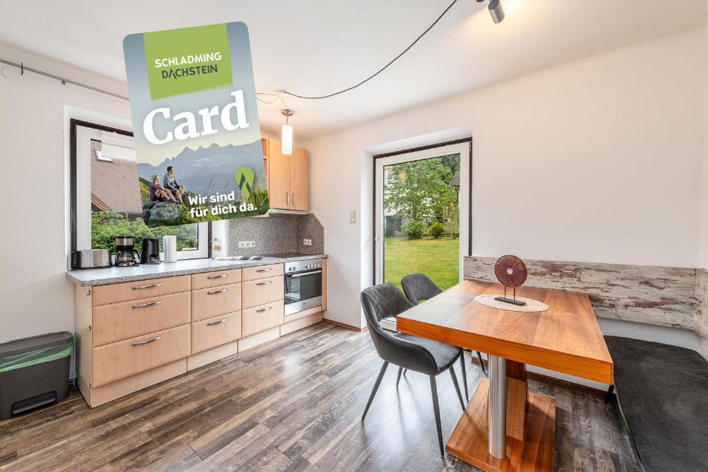 a kitchen and dining room with a table and chairs at apartHAUS - by myNests in Haus im Ennstal