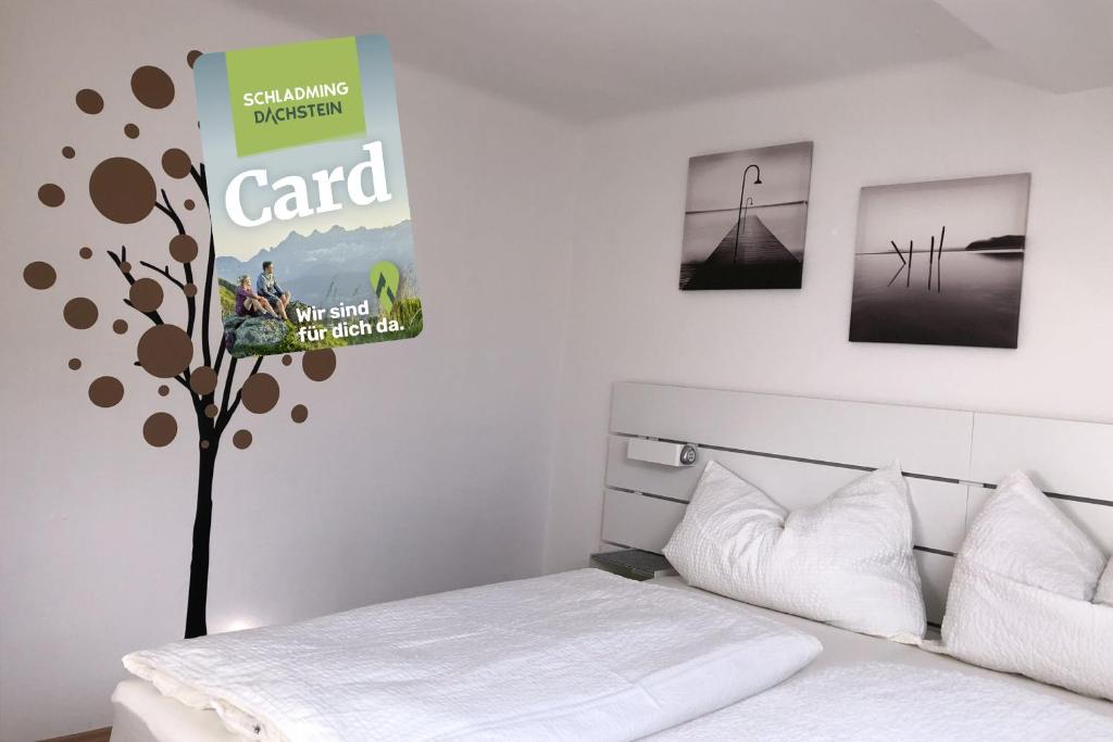 a bedroom with a bed and a poster on the wall at Apartment zur Schmiede - by myNests in Gröbming