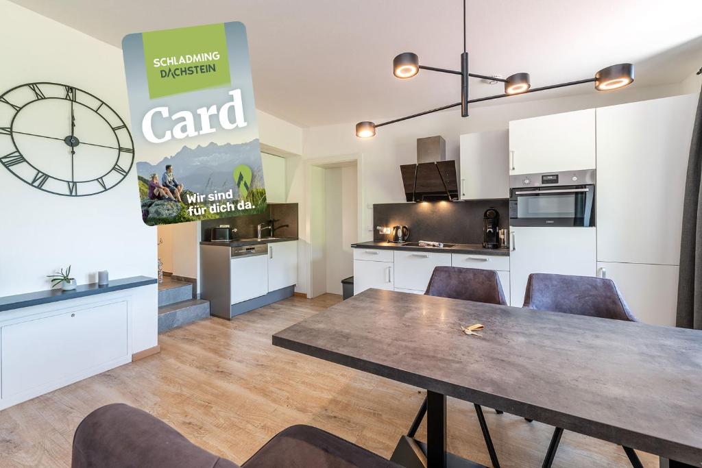 a kitchen and dining room with a table and chairs at Mountain Love Appartements - by myNests in Haus im Ennstal