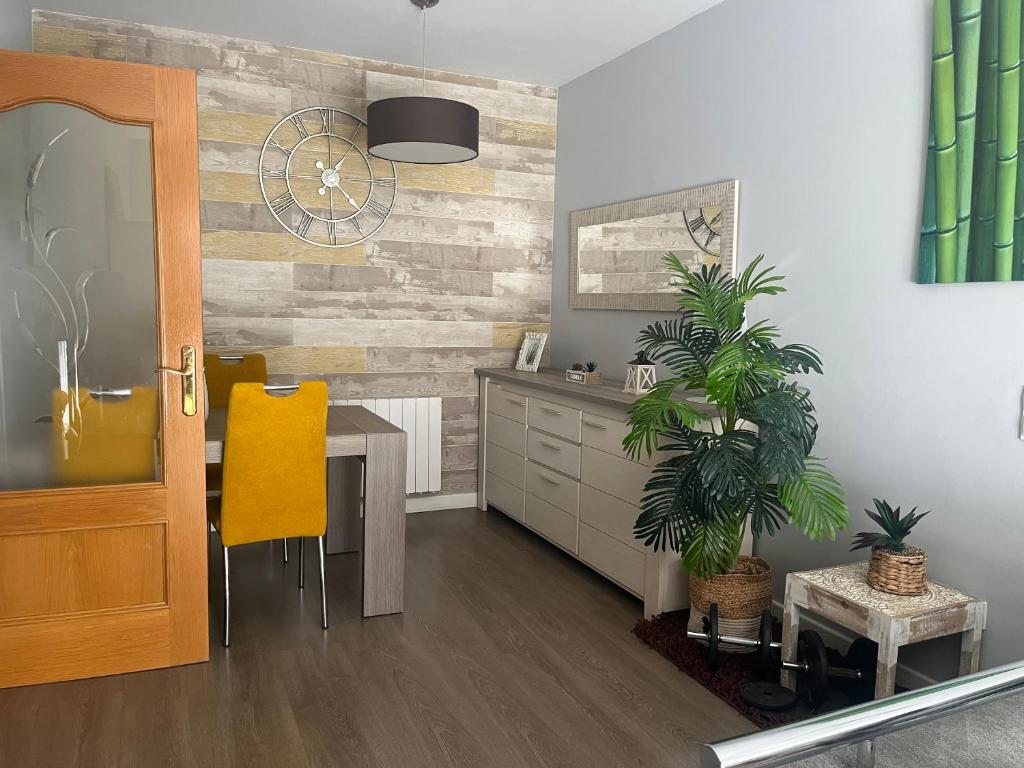 a dining room with a table and a yellow chair at Apartment - Ampolla in L'Ampolla