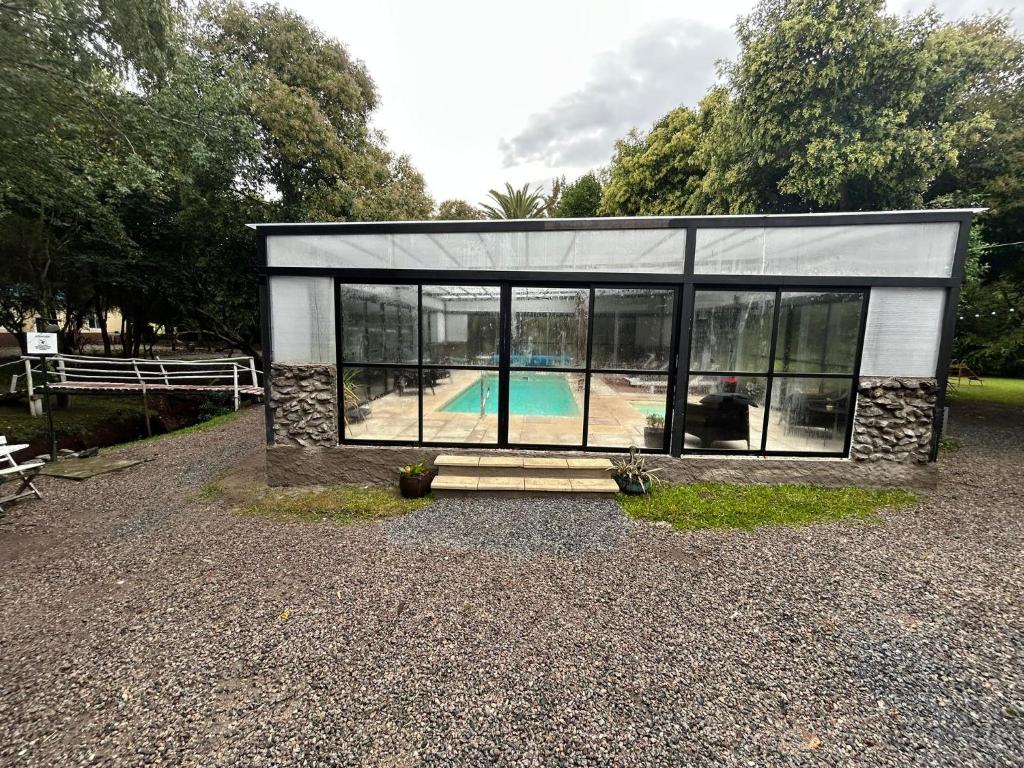 a small house with a pool inside of it at Chacra La Escondida in Colonia del Sacramento