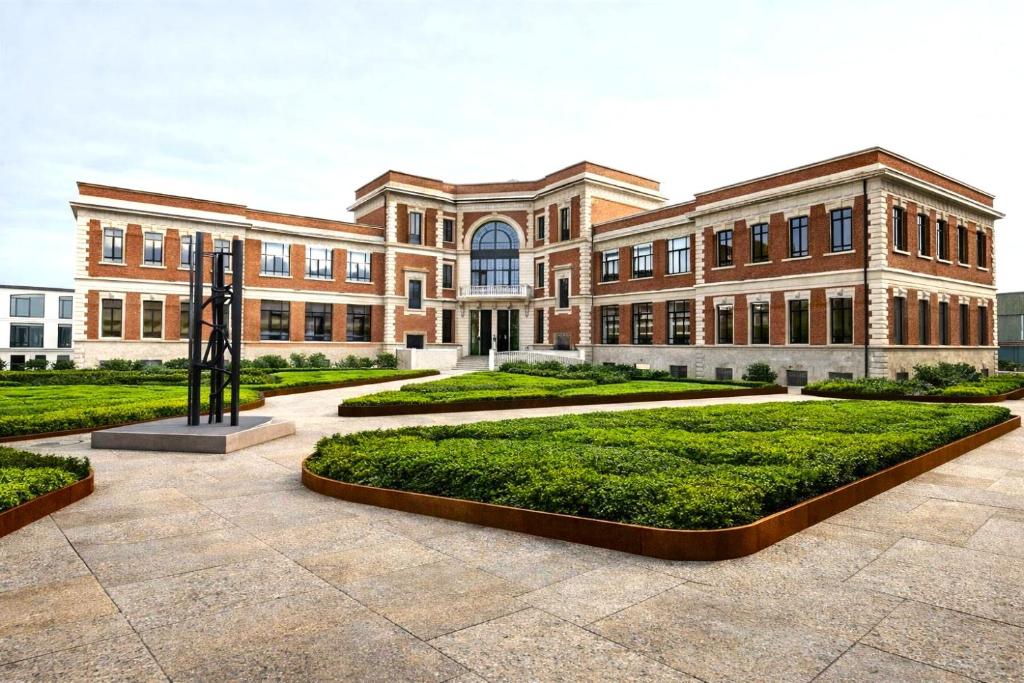 a large brick building with a large courtyard at Breda Suites Hotel Milano in Milan