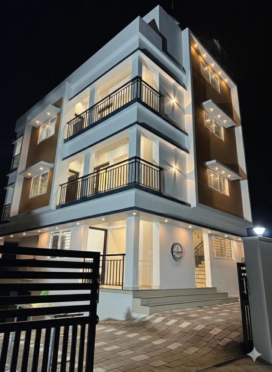 a large building with a black bench in front of it at JK Homes in Alwaye