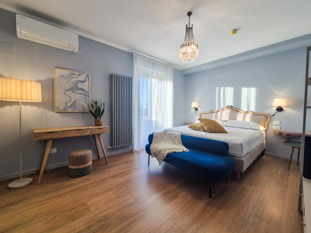 a blue bedroom with a bed and a table at My Tuscany Turquoise Suite in San Quirico dʼOrcia