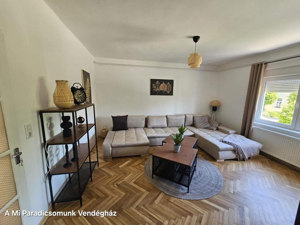 a living room with a couch and a table at vendégház A Mi Paradicsomunk in Palotabozsok