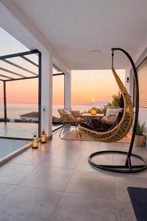 a living room with a hammock and a view of the ocean at Mirage Luxury Living in Nea Potidaea