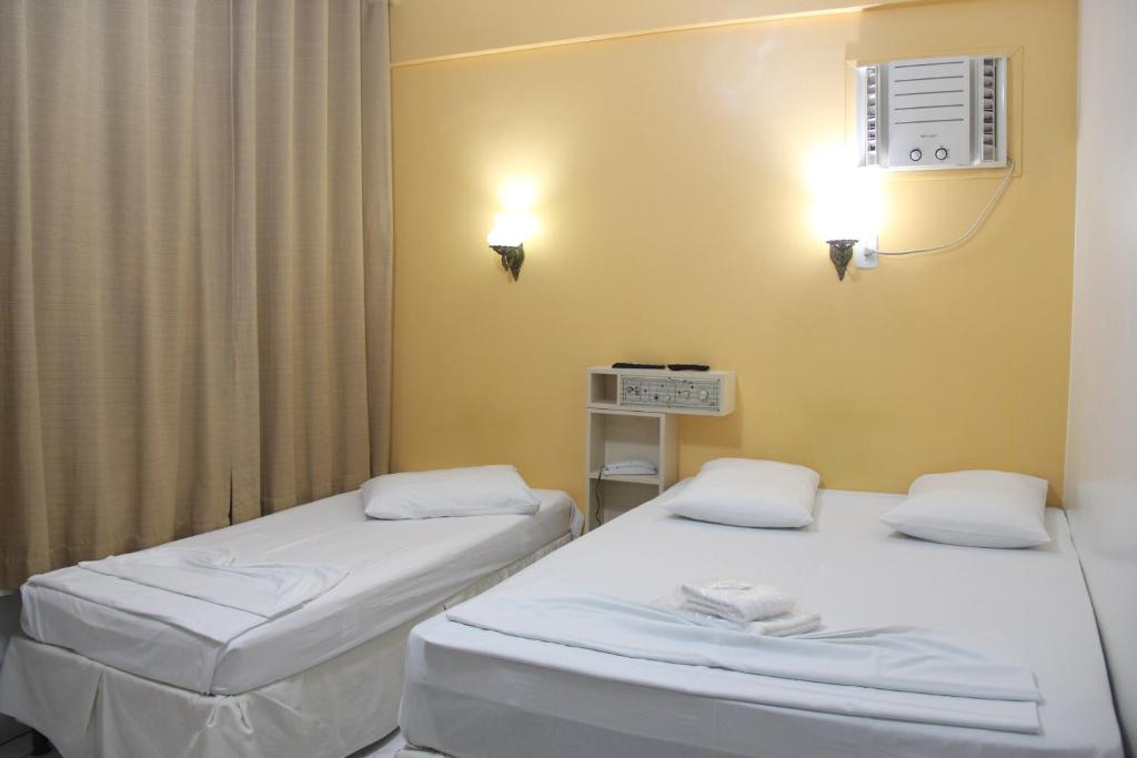a hospital room with two beds and a fan at Oasis Chartouni Hotel in Blumenau