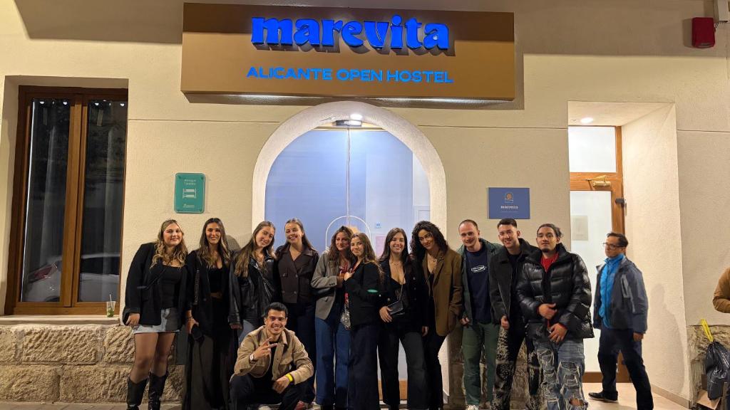 a group of people standing in front of a building at Marevita Hostel in Alicante