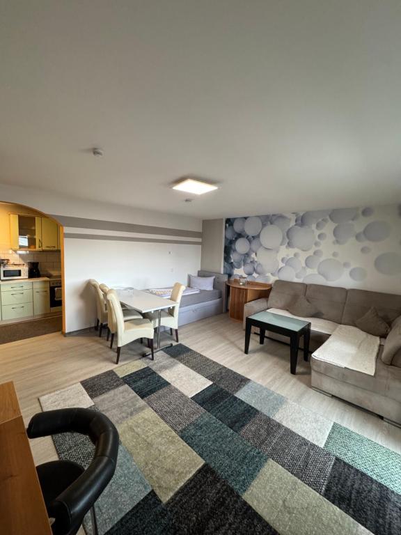 a living room with a couch and a table at Hellwig Ferienwohnung 1 in Bernburg