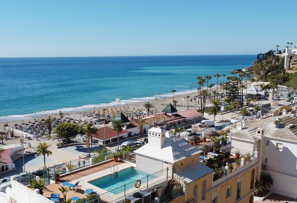 an aerial view of a resort with the beach at Apartamentos HC Burriana Playa in Nerja