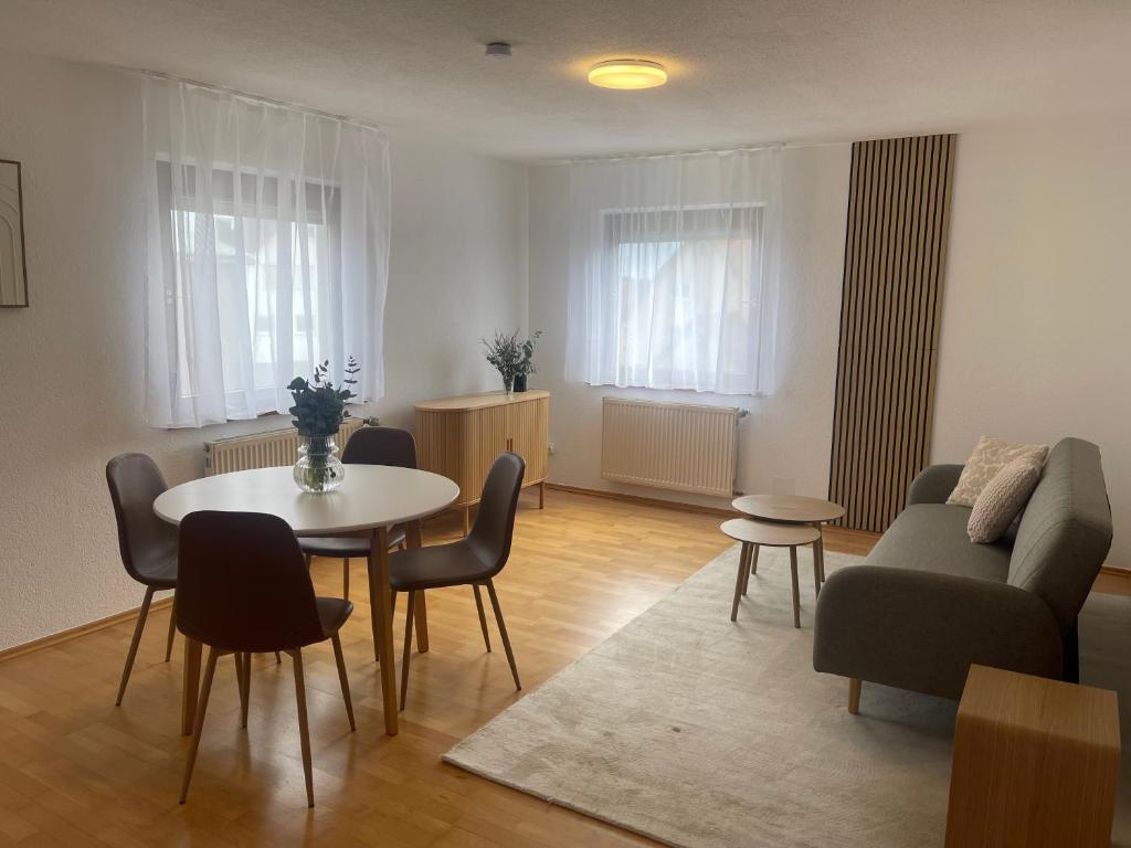 a living room with a table and a couch at Gästeapartment in ruhiger Lage in Rainau