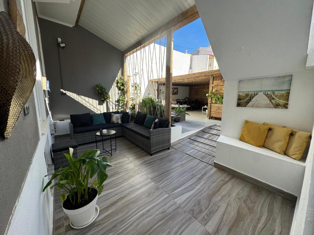 a living room with a couch and a table at Costa Paradise Beach in Costa da Caparica