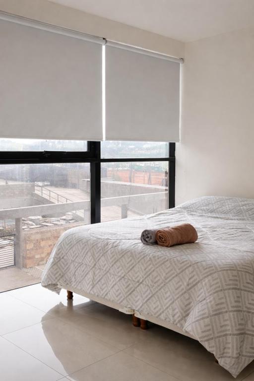 a bedroom with a bed and a large window at Depto Puerto Amarras III in Santa Fe