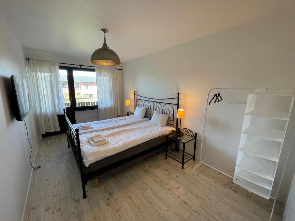 a bedroom with a bed with a black bed frame at Fjordhotellet in Lysekil