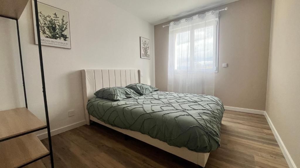 a small bedroom with a bed and a window at les jumelles villa 1 in Saint-Gaudens