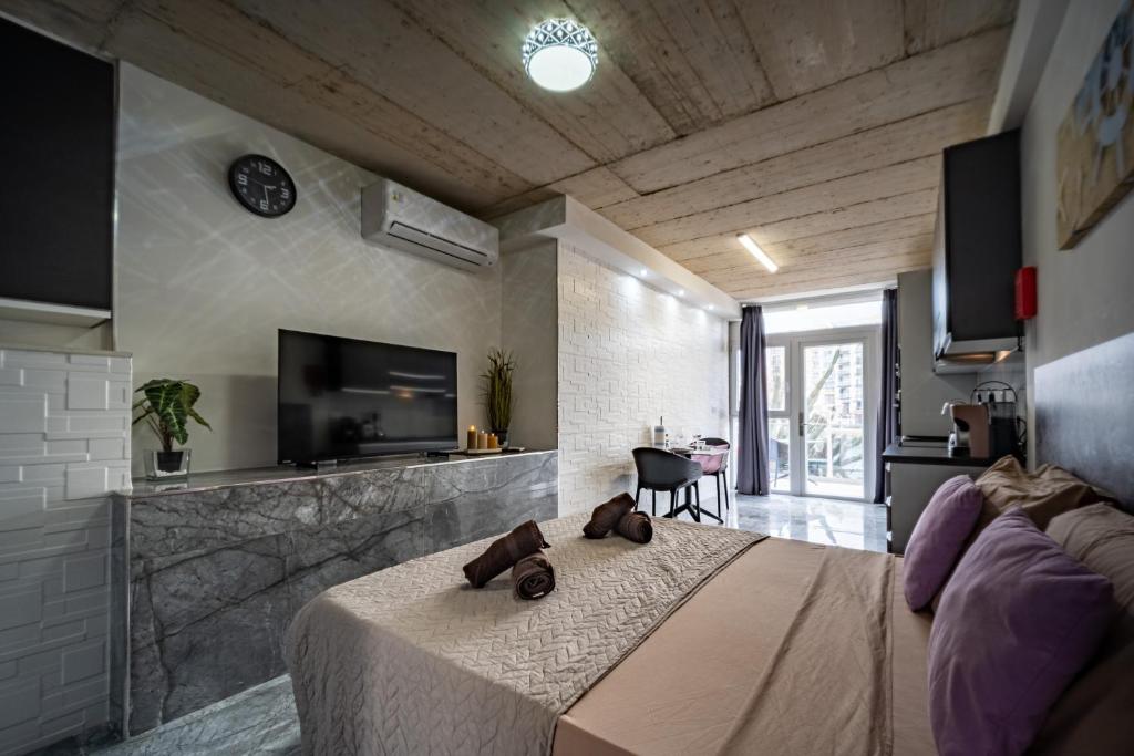 a bedroom with a bed with two brown bears on it at Seafront, lovely modern studio. in St. Julianʼs