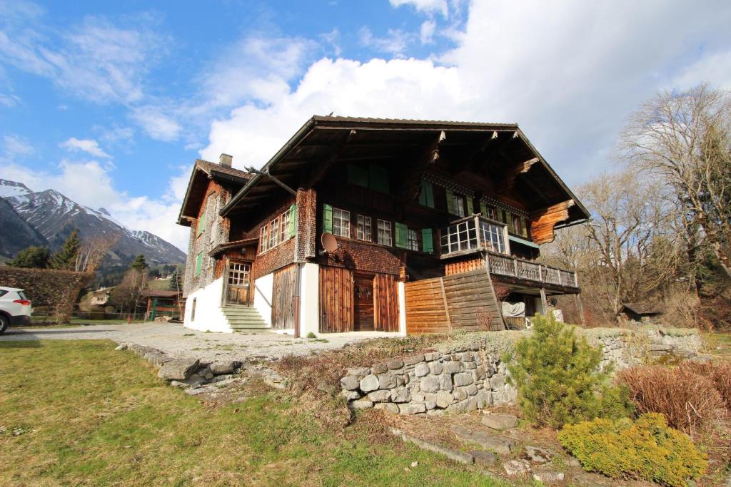 a large wooden house on top of a hill at Chalet Vallonette in Chateau-d'Oex