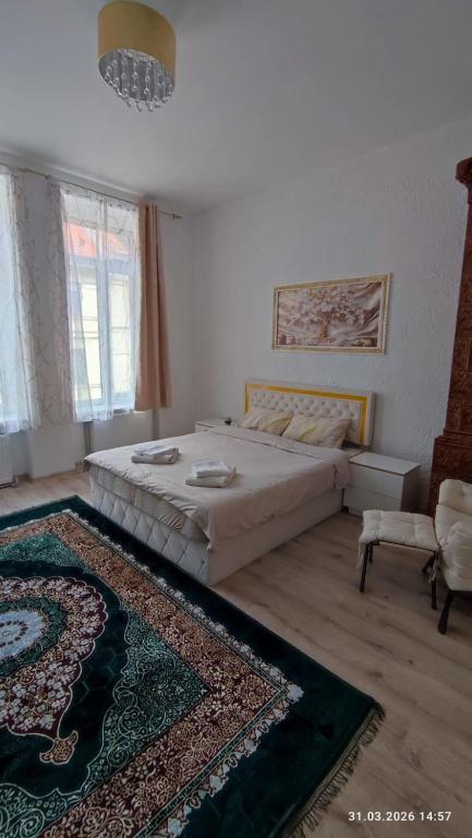 a bedroom with a large bed and a rug at Apartments Angels o k b S2 in Altenburg