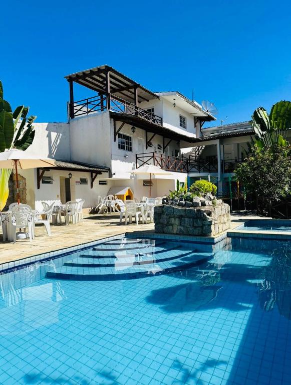 a swimming pool in front of a building at Pousada Pérola do Mar in Tamandaré