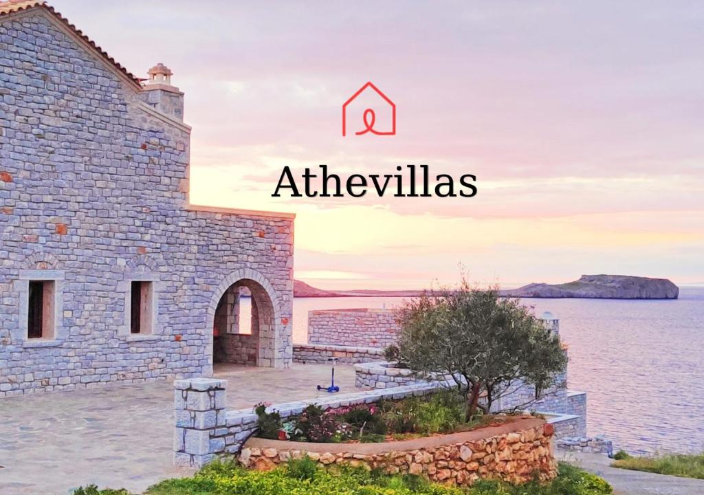 a stone house with a view of the water at Athevillas Antonis in Mína