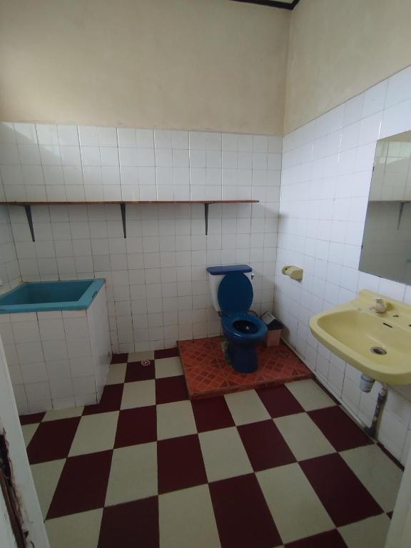 a bathroom with a blue toilet and a sink at Villa Mega molek in Pondok Cipaseban