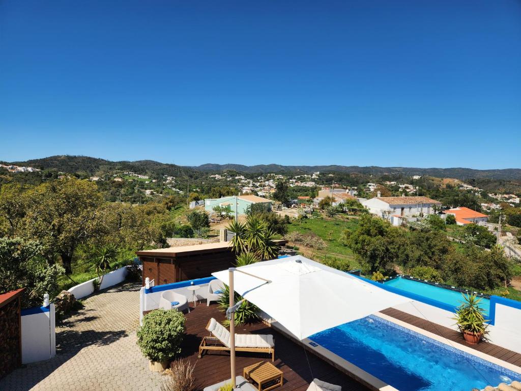 a villa with a swimming pool and a view at Casa Bella Studio in São Brás de Alportel