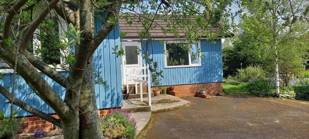 a blue house with a white door at The Annexe in Kirkcudbright