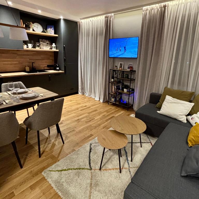 a living room with a couch and a table at Ski-in Flat Next to Ski Road at Mountain View in Bansko