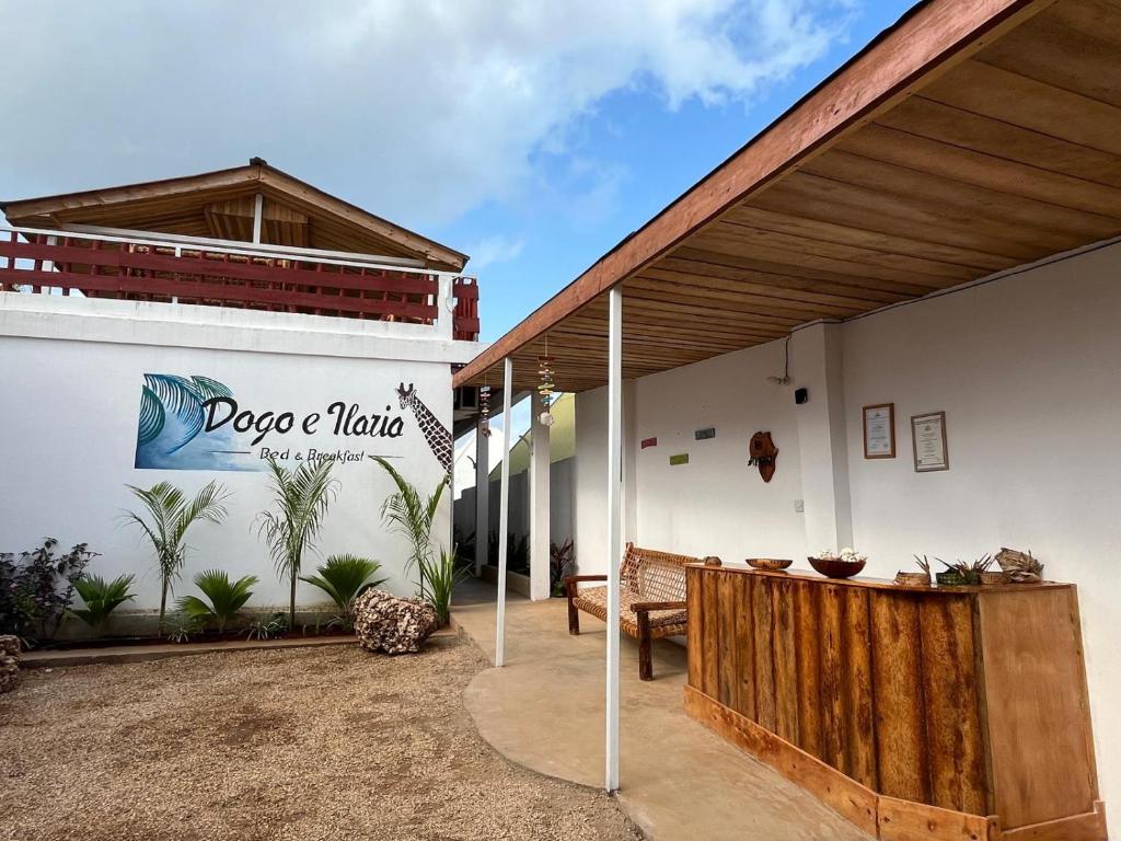 a building with a sign on the side of it at DOGO E ILARIA Bed & Breakfast in Nungwi