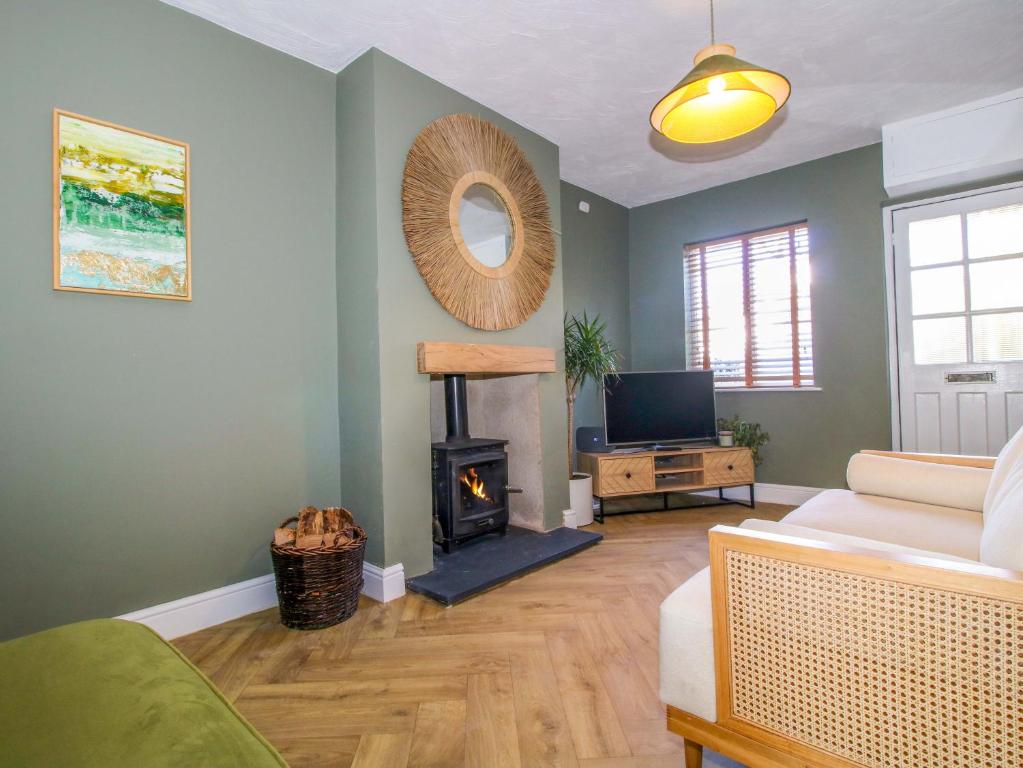 a living room with a couch and a fire place at Cheshire Views in Malpas