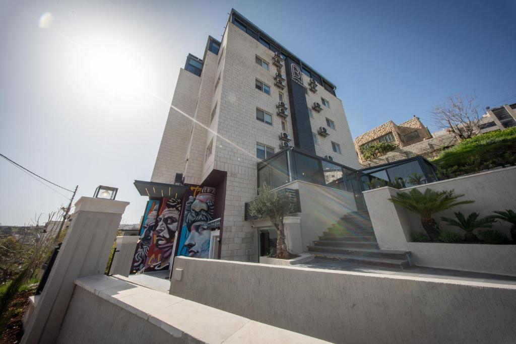 a tall building with stairs in front of it at B Suites Boutique Hotel in Amman