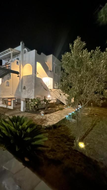 a large white building with a tree in front of it at Blue House Naxos in Naxos Chora