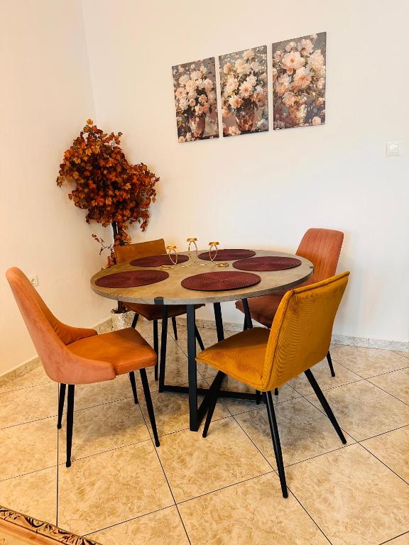 a dining room table with chairs and a vase at Dryrivers house in Xiropótamos