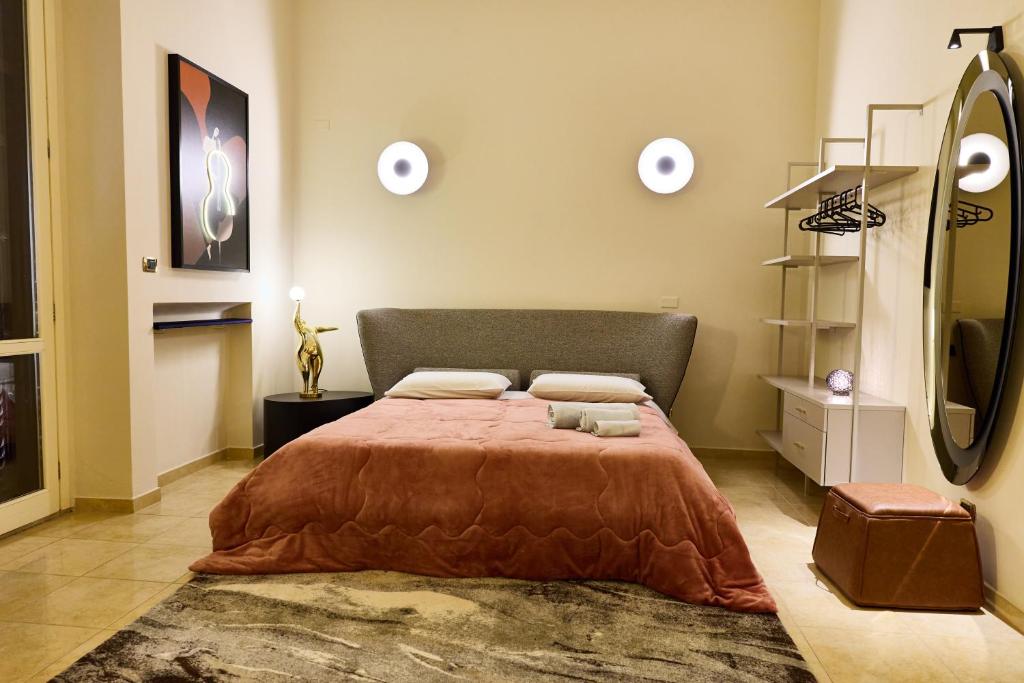 a bedroom with a large bed with a brown blanket at Tiare' in Trani