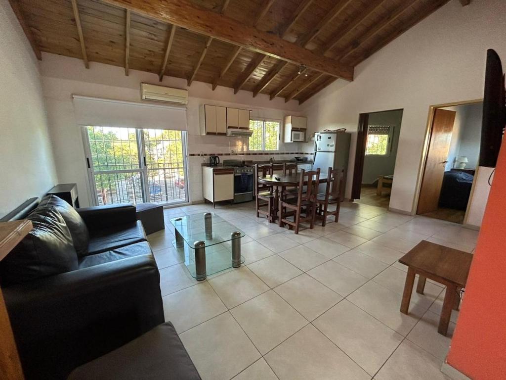 a living room and kitchen with a couch and a table at Departamento Martinez in Martínez