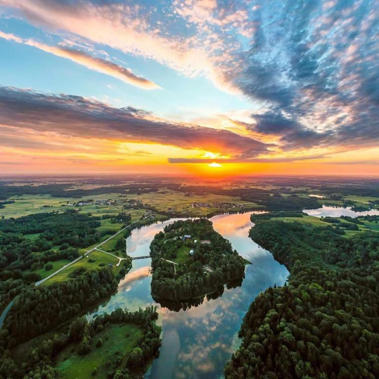 an aerial view of a river at sunset at Obuoliu sala Moletu Vila in Gaylyunay