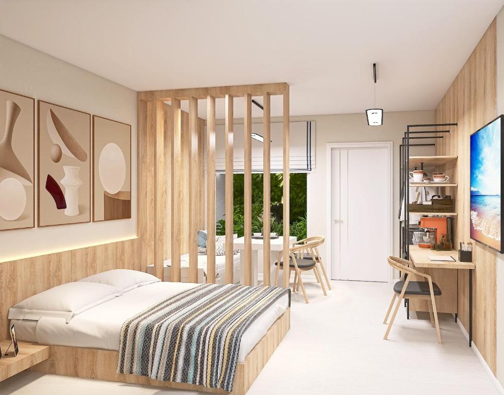 a bedroom with a bed and a dining room at KIBO Boutique in Frumuşani