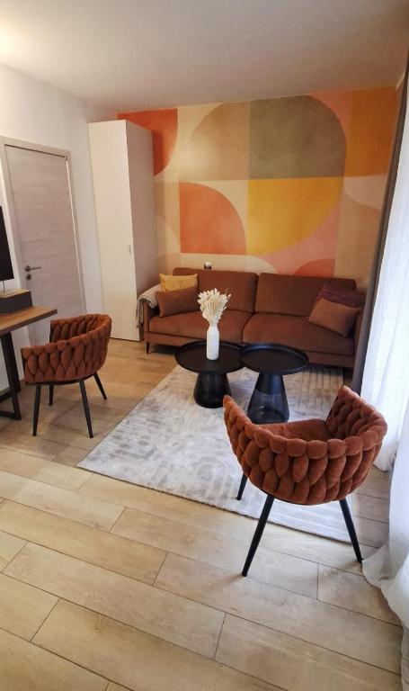 a living room with a couch and a table and chairs at Le "BonLieu" - Annecy Lac & Centre Ville in Annecy