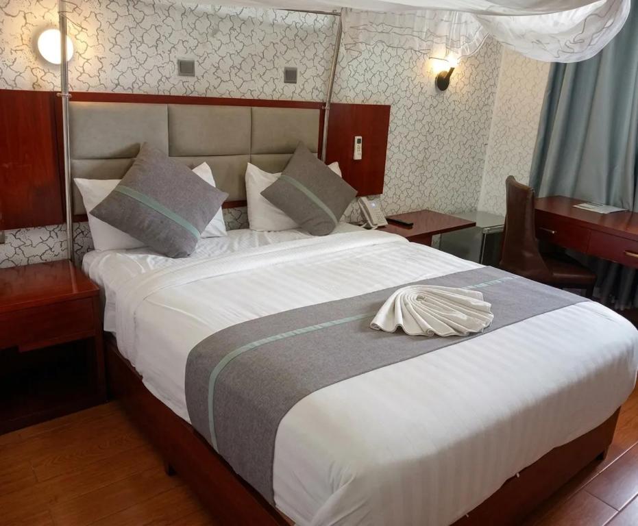 a large bed in a hotel room with at Fidel Hotel in Bahir Dar