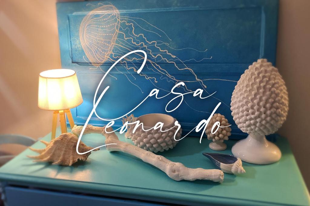 a blue dresser with a lamp and some balls on it at Casa Leonardo in Favignana