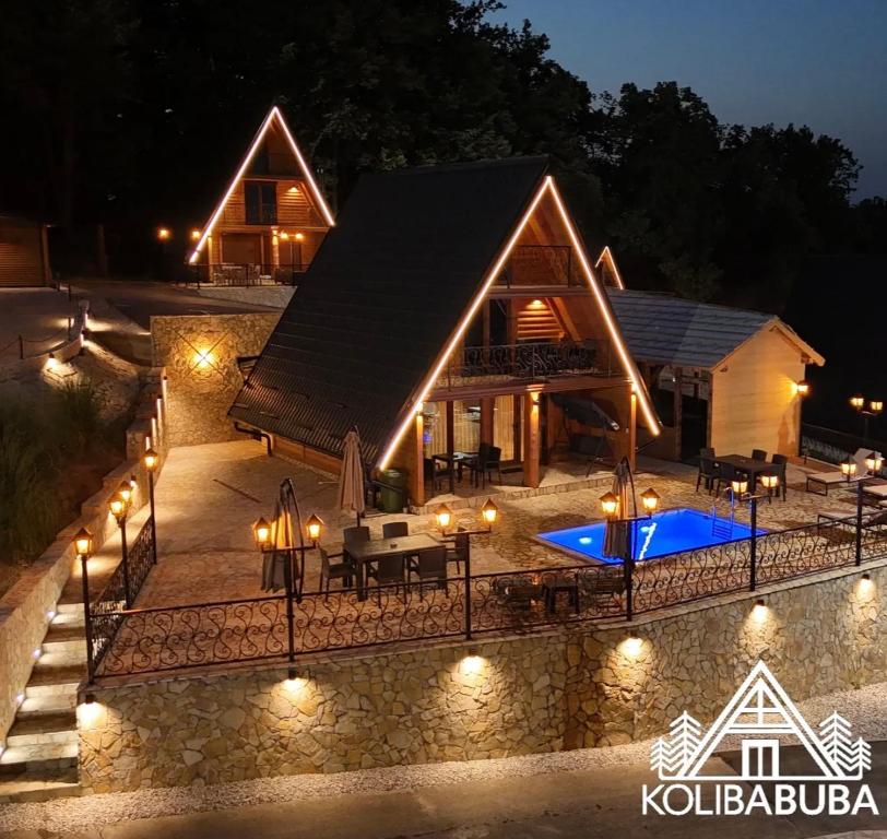 an image of a house at night with lights at Koliba Buba in Brčko