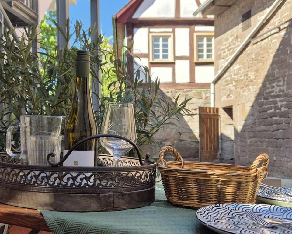 a bottle of wine and a basket on a table at Landhotel Kachelofa in Vaihingen an der Enz