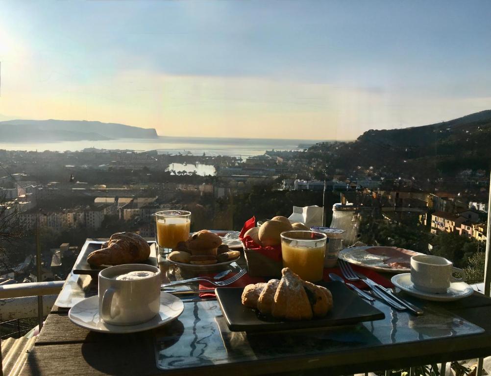 a table with plates of food and cups of coffee at 88 Miglia in La Spezia