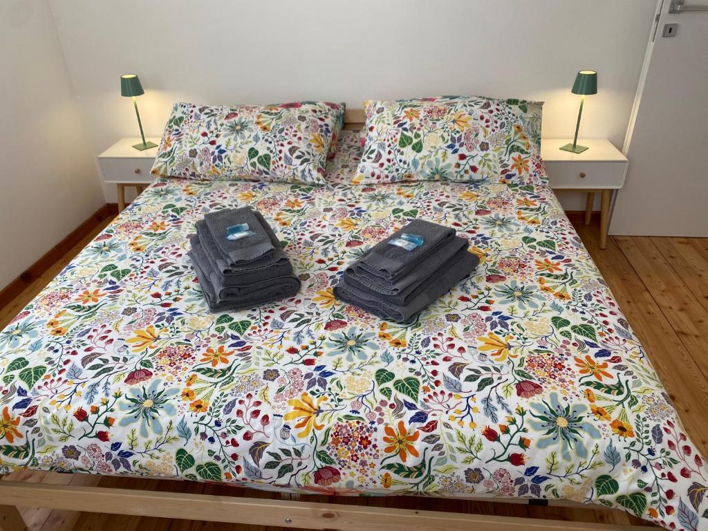 two bags sitting on top of a bed at Affittacamere Torrione in Venzone