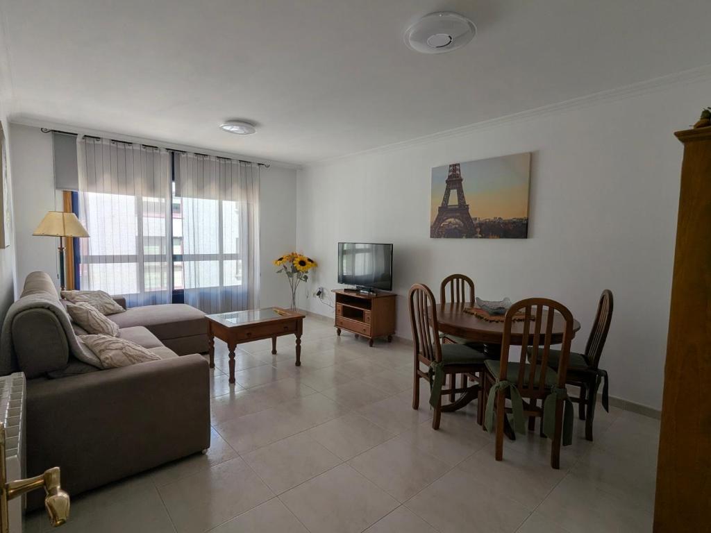 a living room with a couch and a table at L&C Codesal in Sanxenxo