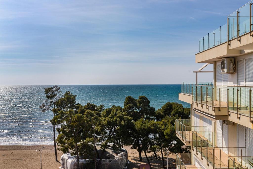a view of the ocean from a building at Beachfront Apartment with Pool Access by PikHost in Lezhë