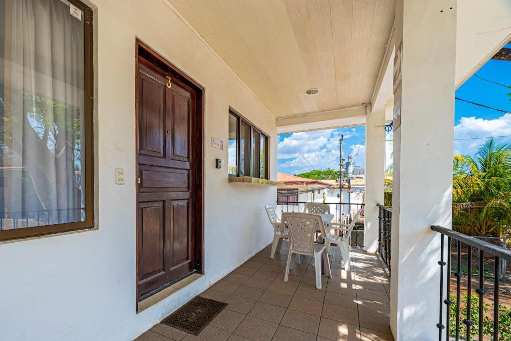 a balcony with a door and a table and chairs at Casa Sol in Carpintero
