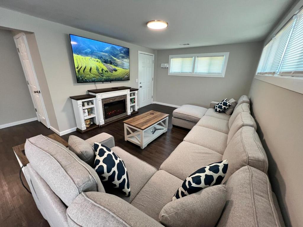 a living room with a couch and a flat screen tv at South Robins Retreat in Warner Robins